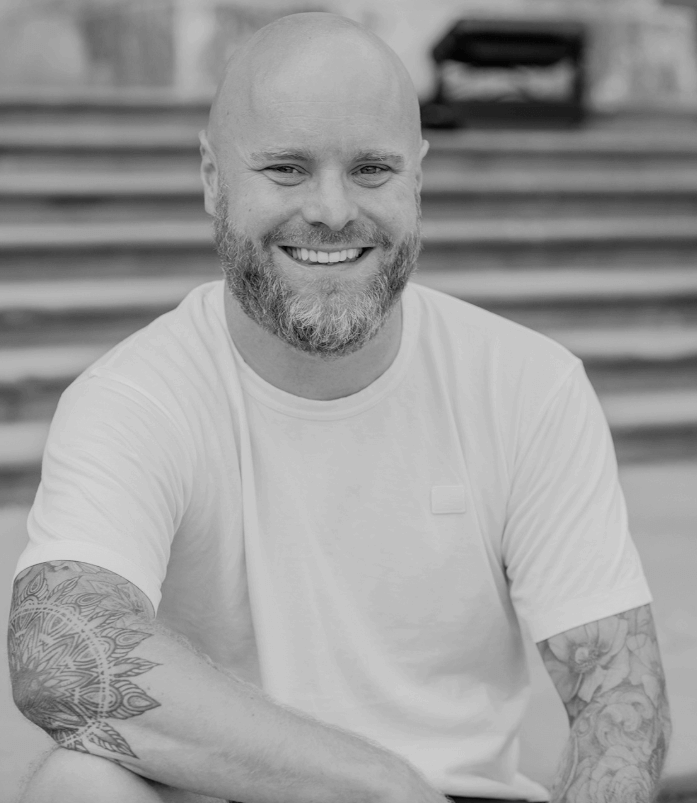 Headshot of a smiling man, sitting down
